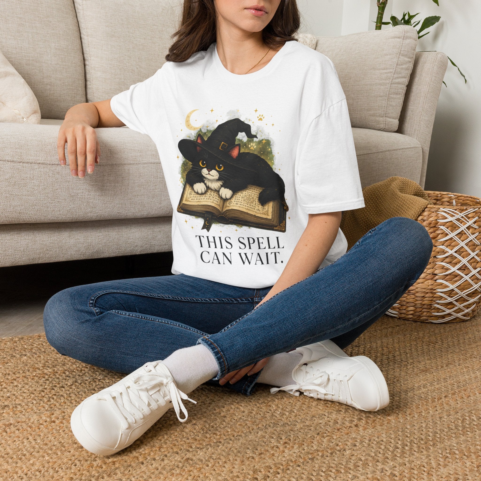 White witchy cat T-shirt featuring Classic Tivis on a spellbook