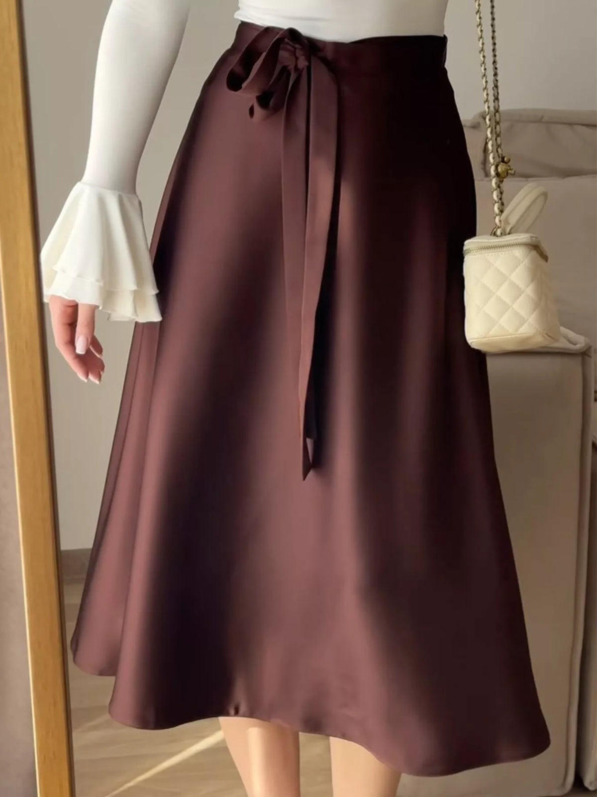 Burgundy satin-look midi skirt with a softly tied waist